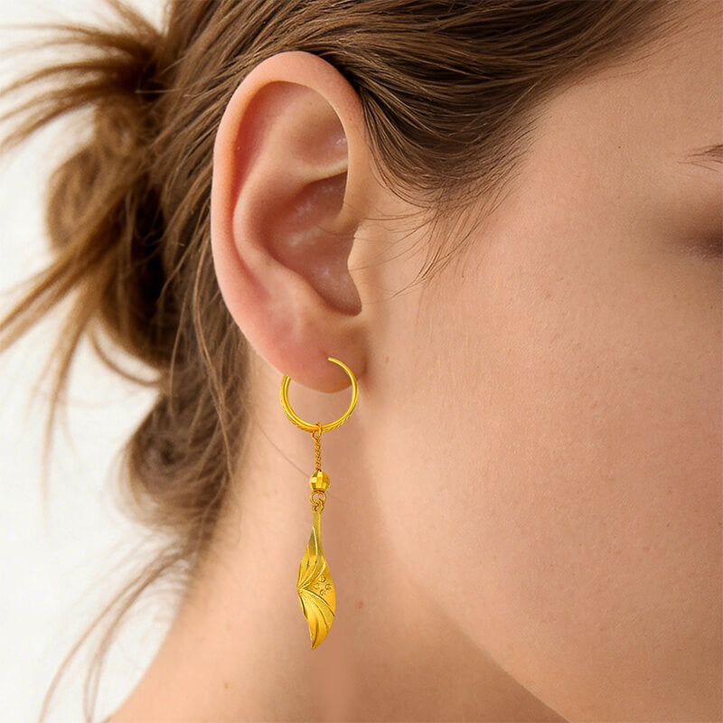 Sunfeel Jewelry 24k gold leaf earring worn by a person with a neutral background